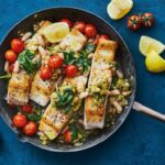 White fish fillets cooked with tomatoes and herbs in a single pan.