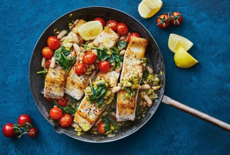 White fish fillets cooked with tomatoes and herbs in a single pan.