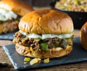 Sloppy joe sandwiches filled with seasoned beef, onions, peppers, and melted cheese.