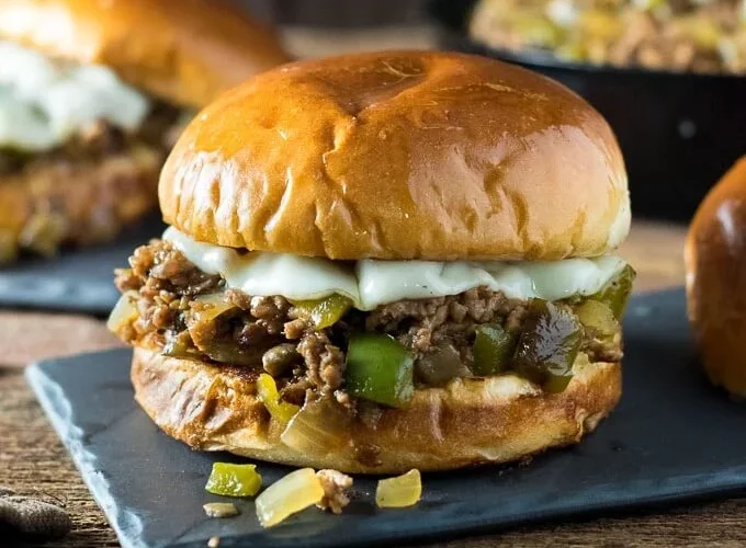 Sloppy joe sandwiches filled with seasoned beef, onions, peppers, and melted cheese.