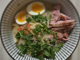 a bowl of soup with meat and noodles