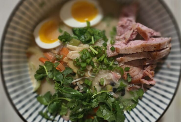 a bowl of soup with meat and noodles