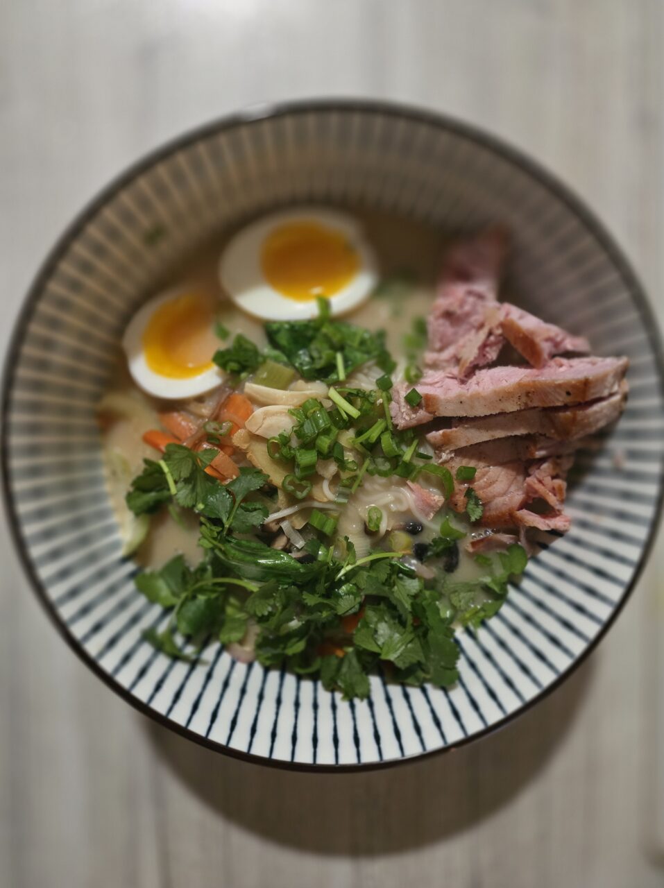 a bowl of soup with meat and noodles