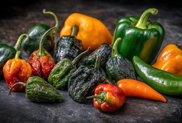 El Patrons Fire Red Salsa Recipe - Authentic Mexican Hot Sauce 26 Vibrant red El Patrons Fire Red Salsa in a rustic molcajete with tortilla chips and lime wedges artfully arranged around it