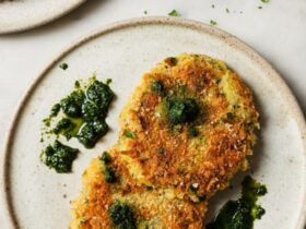 Golden crispy air fryer tikkis arranged on a white plate with vibrant green curry sauce and fresh cilantro garnish