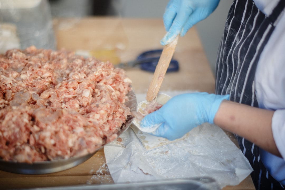 Lebanese Kafta Kebabs: Healthy Grilled Perfection with Aromatic Spices 27 Hands mixing ground beef with fresh herbs and spices in a large bowl, showing the proper texture before shaping