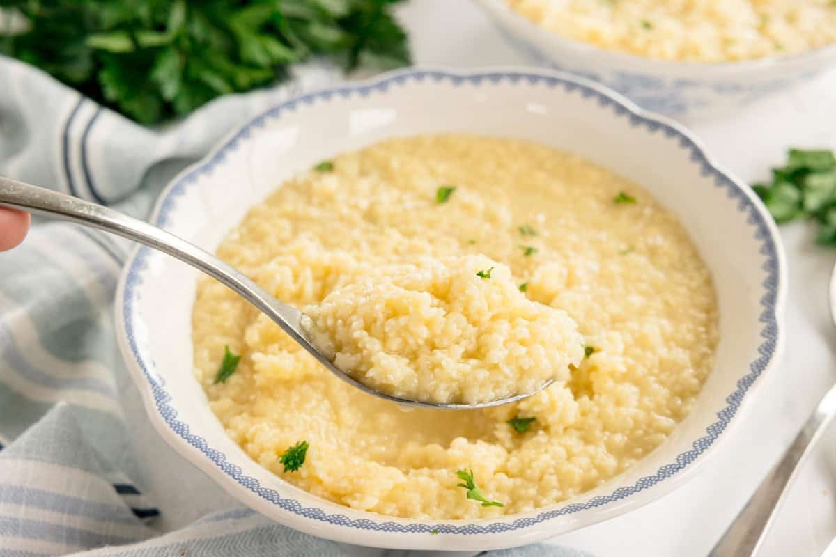 Buttered Pastina Recipe - Simple, Nourishing Italian Comfort Food 26 Creamy buttered pastina in a white ceramic bowl garnished with fresh parsley and grated Parmesan cheese