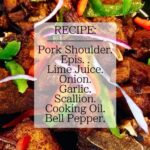 Crispy golden Haitian griot pork pieces garnished with fresh herbs on a white platter with lime wedges