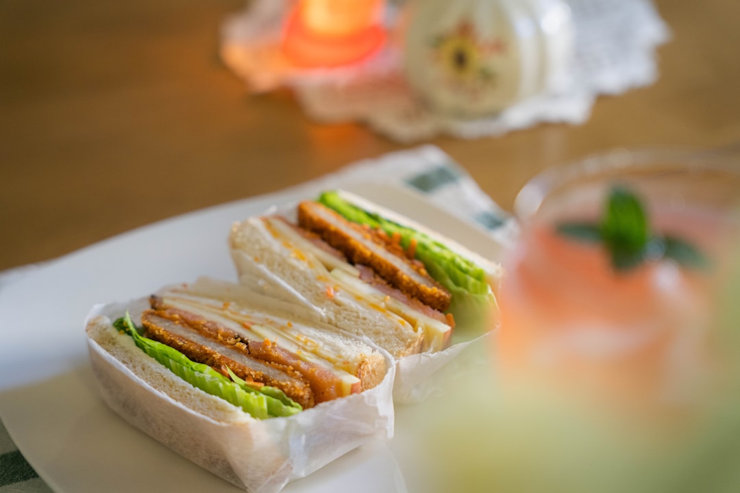 Healthy Banh Mi Sandwich - Vietnamese Street Food with Clean Ingredients 26 Beautiful banh mi sandwich cut in half showing colorful layers of pickled vegetables, fresh herbs, protein and Vietnamese mayo on crusty French bread