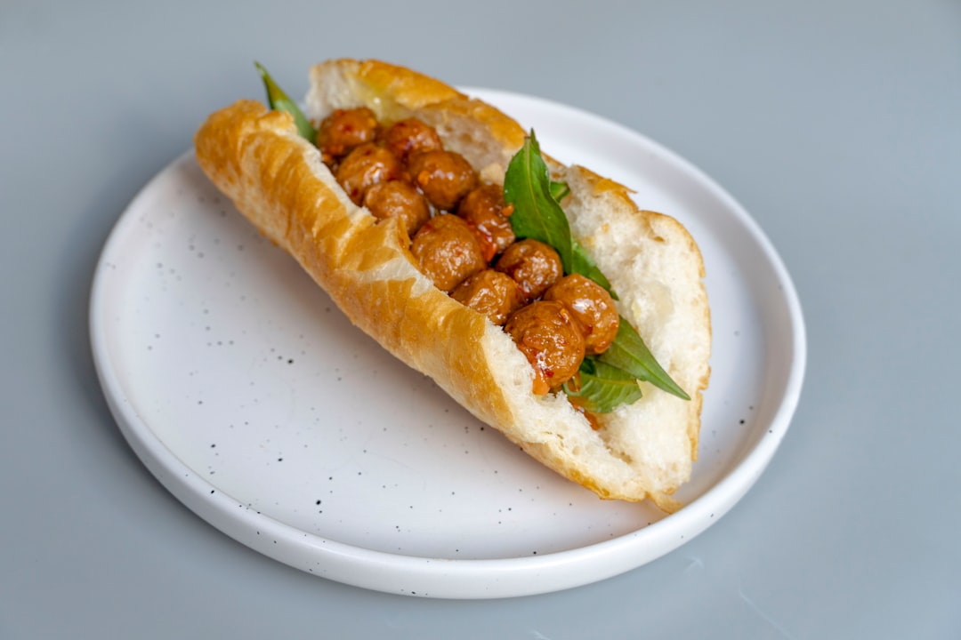 Healthy Banh Mi Sandwich - Vietnamese Street Food with Clean Ingredients 27 Ingredients laid out for banh mi including pickled vegetables, fresh herbs, marinated protein, and sliced baguette