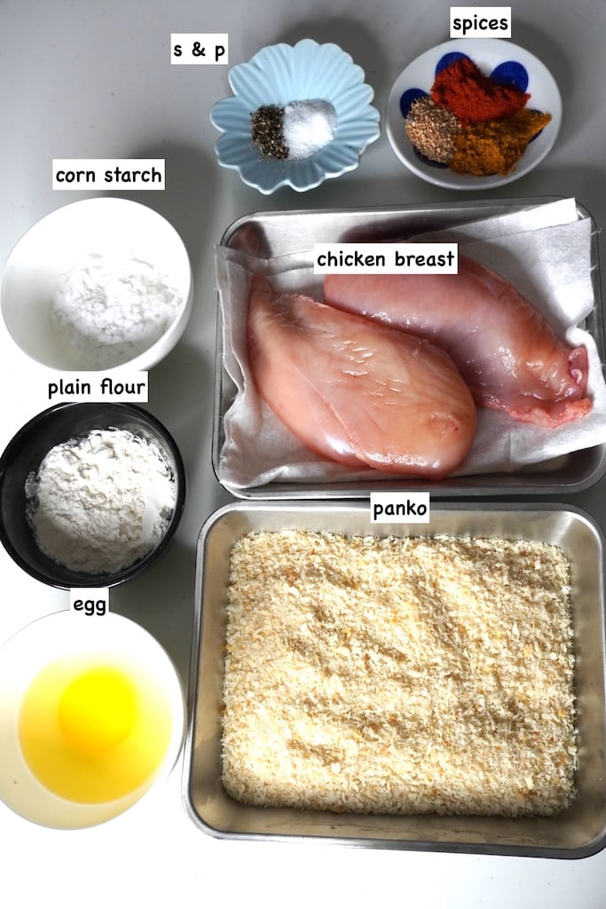 Japanese Chicken Katsu - Crispy, Protein-Packed Comfort Food Worth the Indulgence 27 Step-by-step shots showing chicken being pounded thin, dredged in flour, dipped in egg, and coated with panko breadcrumbs on a marble countertop