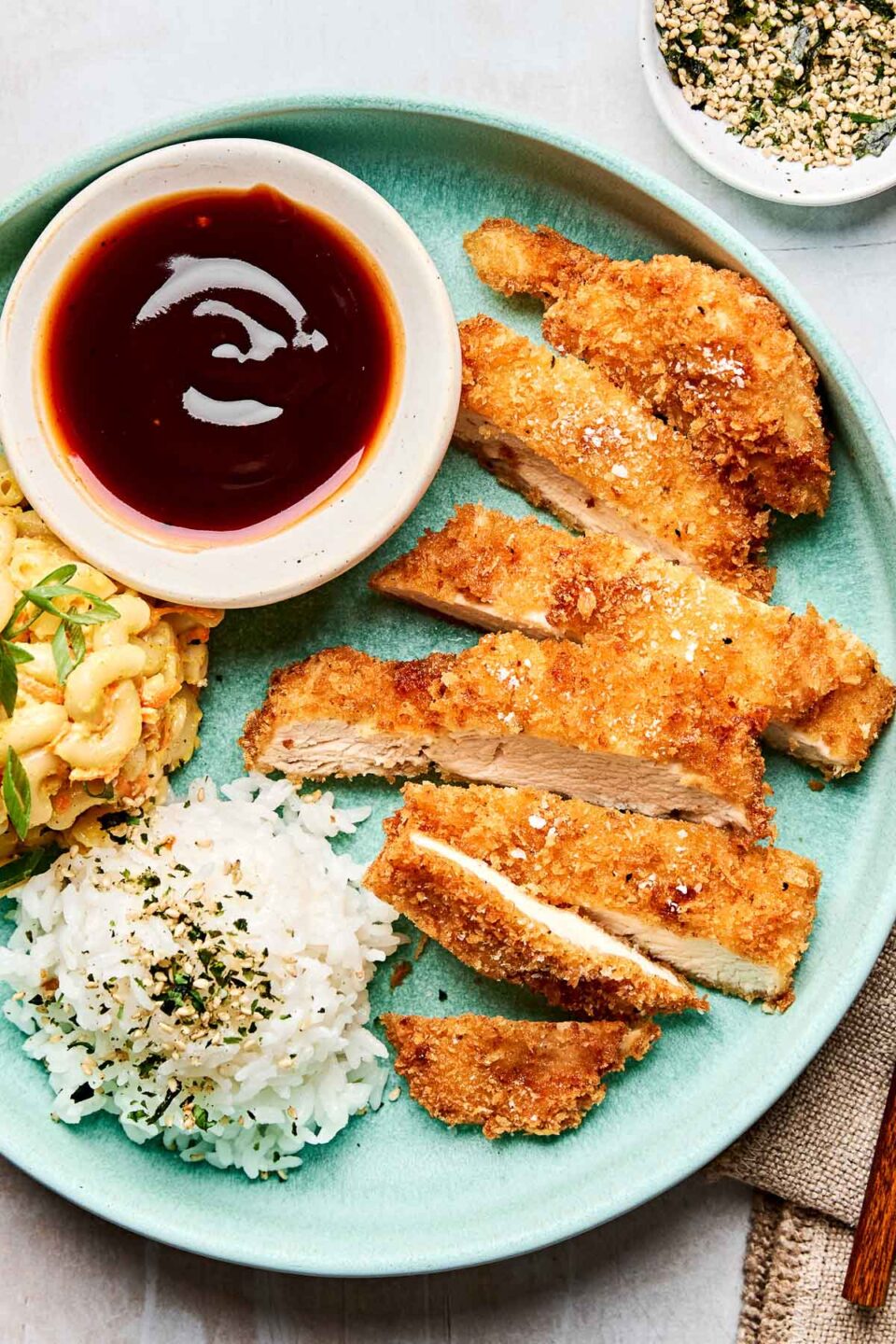 Japanese Chicken Katsu - Crispy, Protein-Packed Comfort Food Worth the Indulgence 28 Close-up shot of sliced chicken katsu showing the golden crispy coating and juicy white meat interior, garnished with fresh herbs on a rustic wooden board