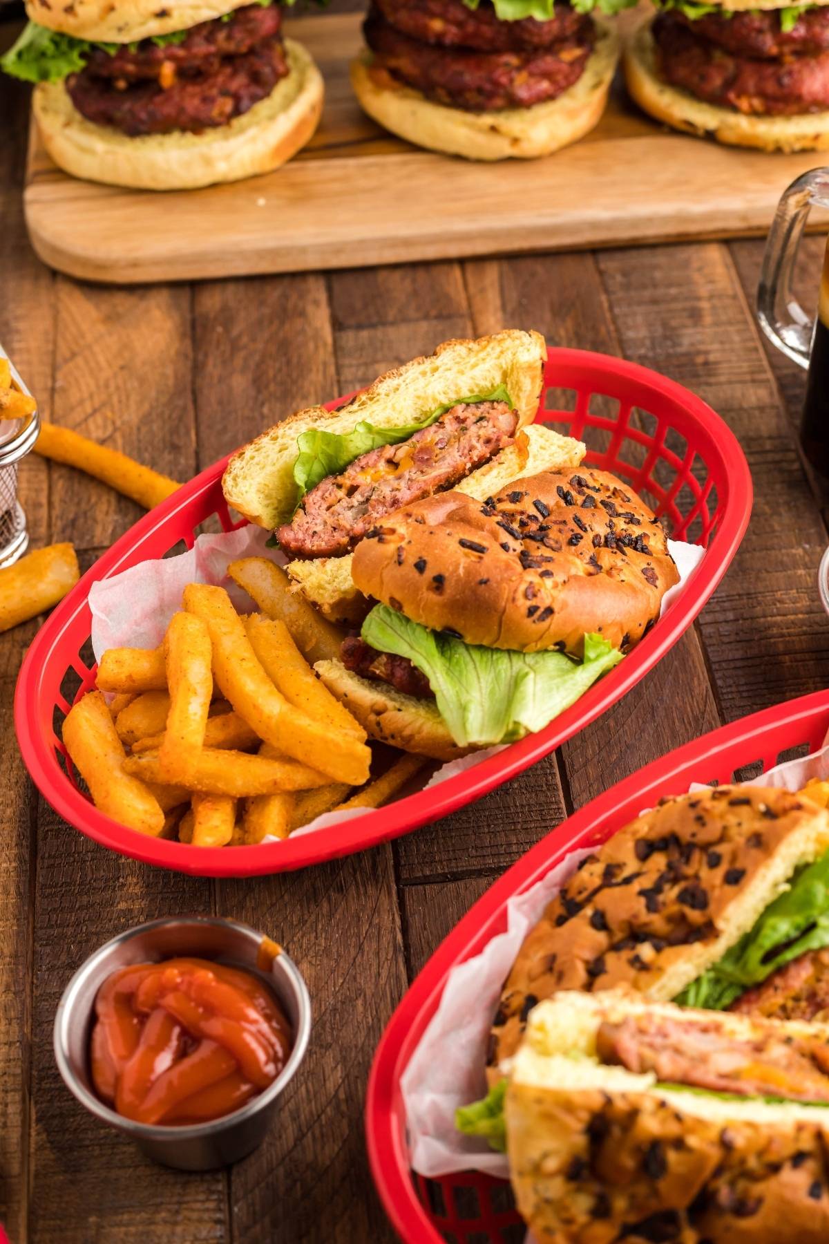Bacon Ranch Burgers — Stuffed Cheddar Ranch Grilled Patty Recipe 26 Bacon Ranch Burgers stacked high on a toasted brioche bun with crispy bacon, lettuce, and tomato on a wooden serving board