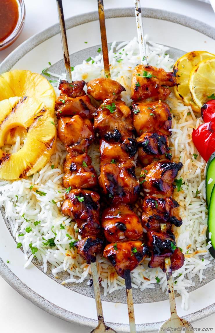 Huli Huli Chicken — Hawaiian Sweet Pineapple BBQ Glaze Recipe 27 Huli Huli Chicken marinade ingredients laid out including pineapple juice, soy sauce, ginger, garlic, and brown sugar with chicken thighs on a cutting board