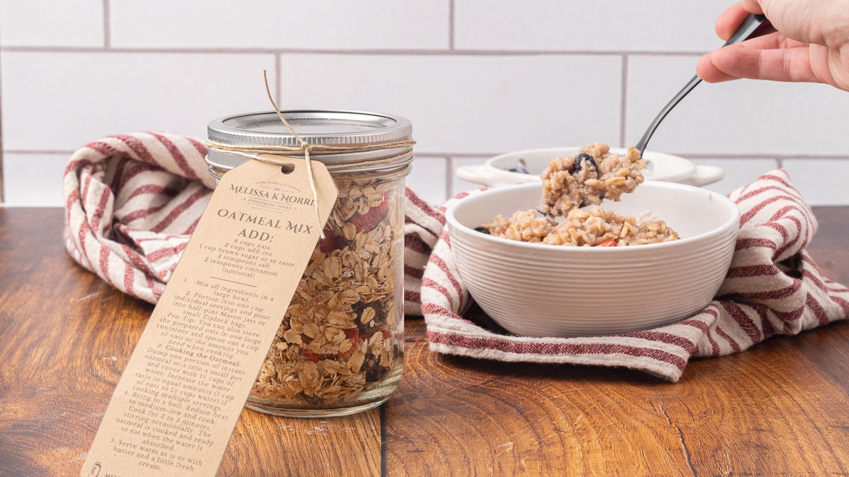 Overnight Camping Oatmeal — The Easy, Nourishing Breakfast You Prep Before You Even Leave Home 27 Flat lay of overnight camping oatmeal ingredients in small bowls — rolled oats, dried cranberries, chopped walnuts, brown sugar, cinnamon, and dried apricots arranged on a rustic wooden surface with mason jars and zip-lock bags nearby
