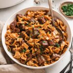 Crockpot Beef and Noodles served in a wide bowl with tender shredded beef over egg noodles in rich brown gravy, garnished with fresh parsley