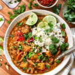 Faux-Massaman Vegetable Curry served over jasmine rice in a wide bowl, garnished with fresh lime and cilantro, golden coconut broth visible