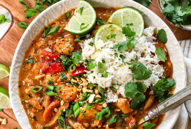 Faux-Massaman Vegetable Curry served over jasmine rice in a wide bowl, garnished with fresh lime and cilantro, golden coconut broth visible