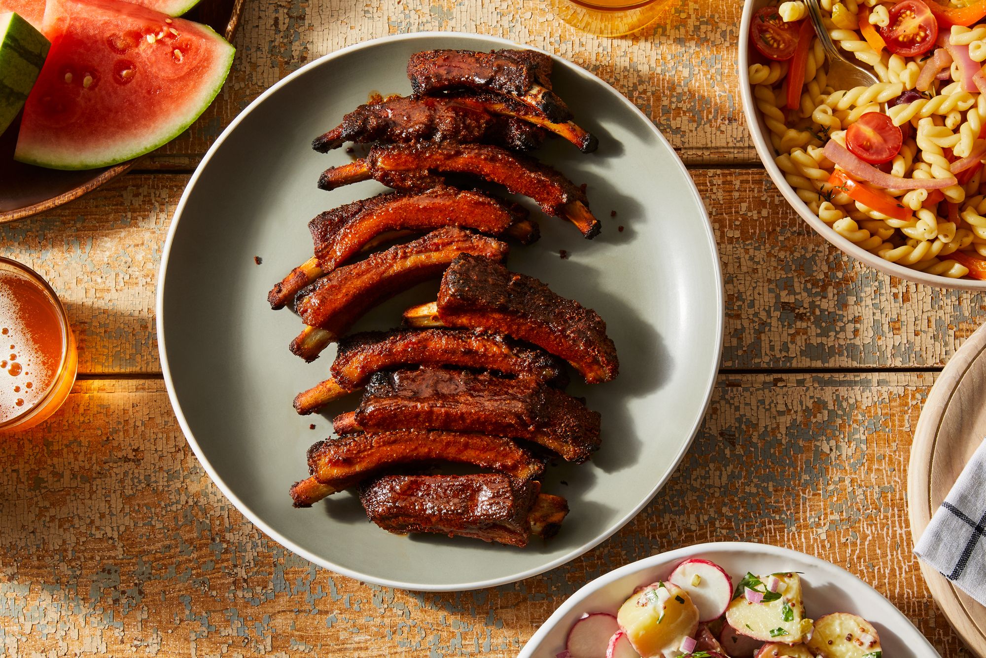 Instant Pot Ribs — Fall-Off-The-Bone Tender in Under an Hour 27 Ingredients for Instant Pot ribs laid flat on a marble surface including rack of baby back ribs, spice rub ingredients, apple cider vinegar, and BBQ sauce