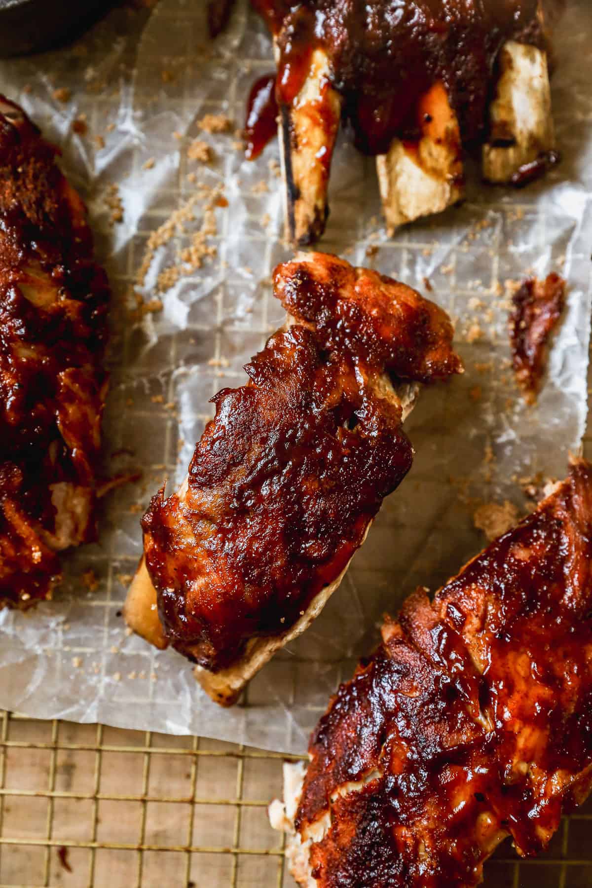 Instant Pot Ribs — Fall-Off-The-Bone Tender in Under an Hour 28 Close-up of glazed Instant Pot ribs being pulled apart showing tender, juicy meat with caramelized BBQ sauce and smoke ring