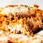 Million Dollar Spaghetti baked casserole golden cheesy top fresh from the oven in a white baking dish