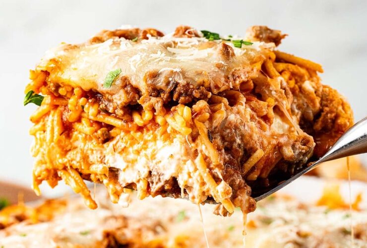 Million Dollar Spaghetti baked casserole golden cheesy top fresh from the oven in a white baking dish
