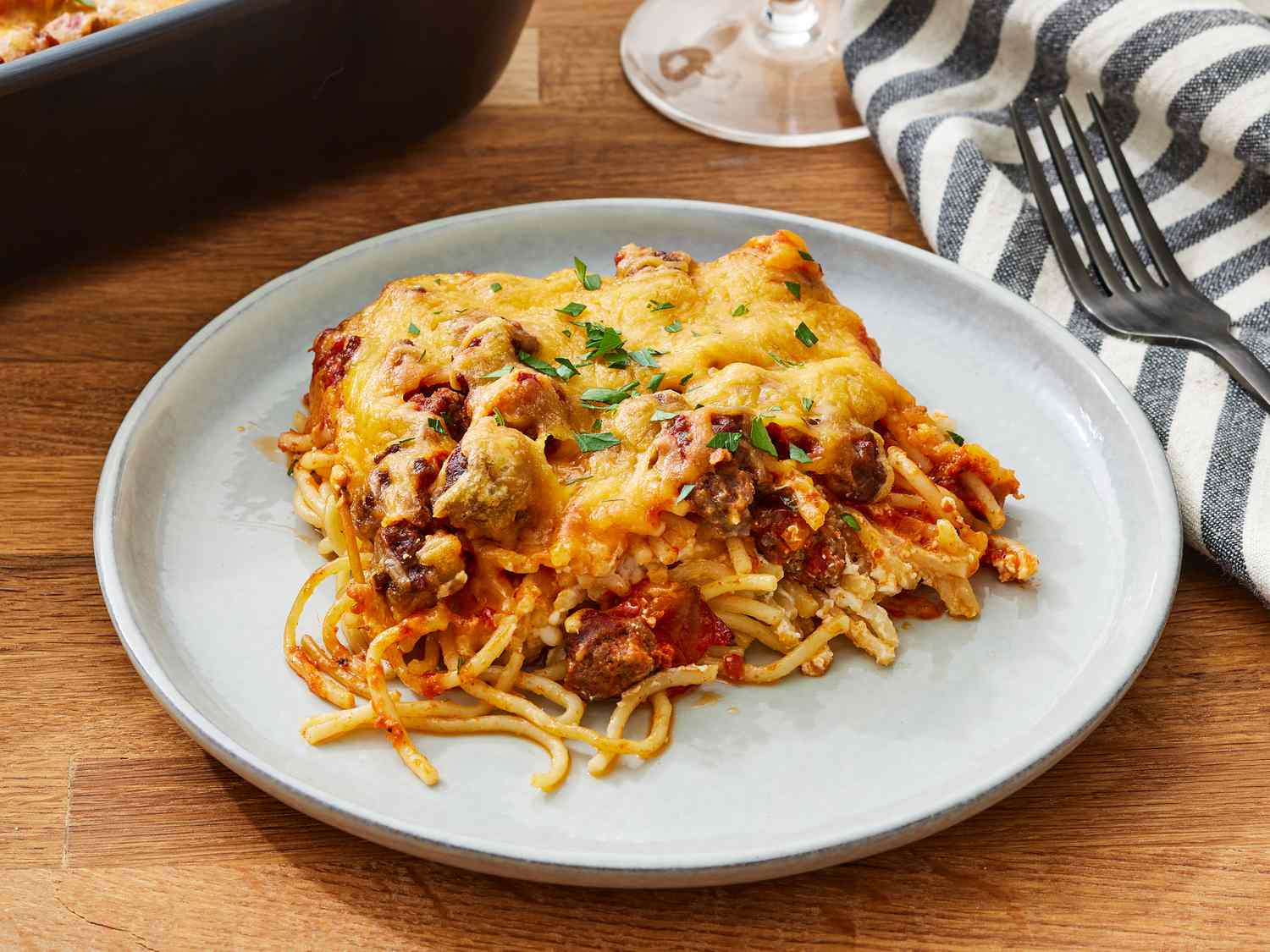 Million Dollar Spaghetti — The Ultimate Comfort Bake That's Worth Every Bite 28 Million Dollar Spaghetti close-up slice being lifted with layers of pasta cream cheese filling and meat sauce visible