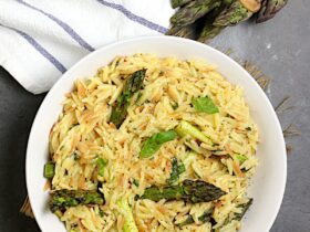 One-Pot Cheesy Orzo with Asparagus — No-Colander Pasta Cooked Entirely in a Single Pot 34 One-pot cheesy orzo with asparagus served in a wide shallow bowl, topped with freshly grated parmesan and cracked black pepper, soft natural light overhead