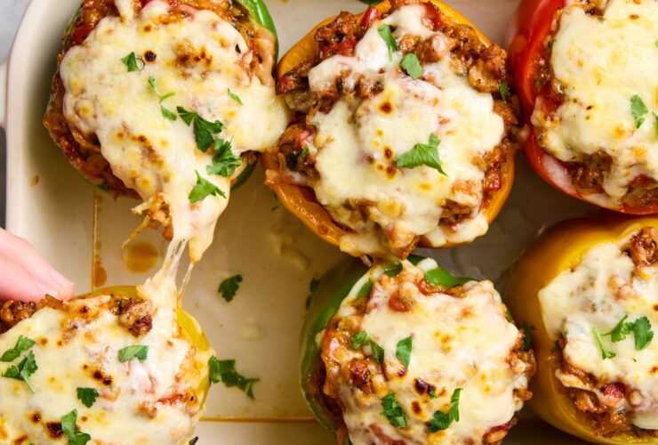 Stuffed Bell Peppers with Ground Beef, Rice & Cheese — The Ultimate Summer Dinner 27 Stuffed bell peppers filled with seasoned ground beef, rice, and melted cheese, beautifully plated on a white dish with fresh herbs garnish