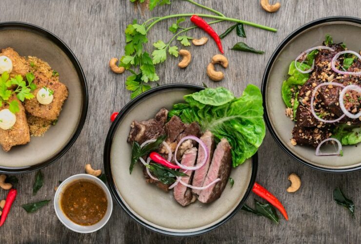 Baba Ganoush served in a shallow bowl drizzled with olive oil and topped with pomegranate seeds, fresh parsley, and a sprinkle of smoked paprika on a rustic wooden board