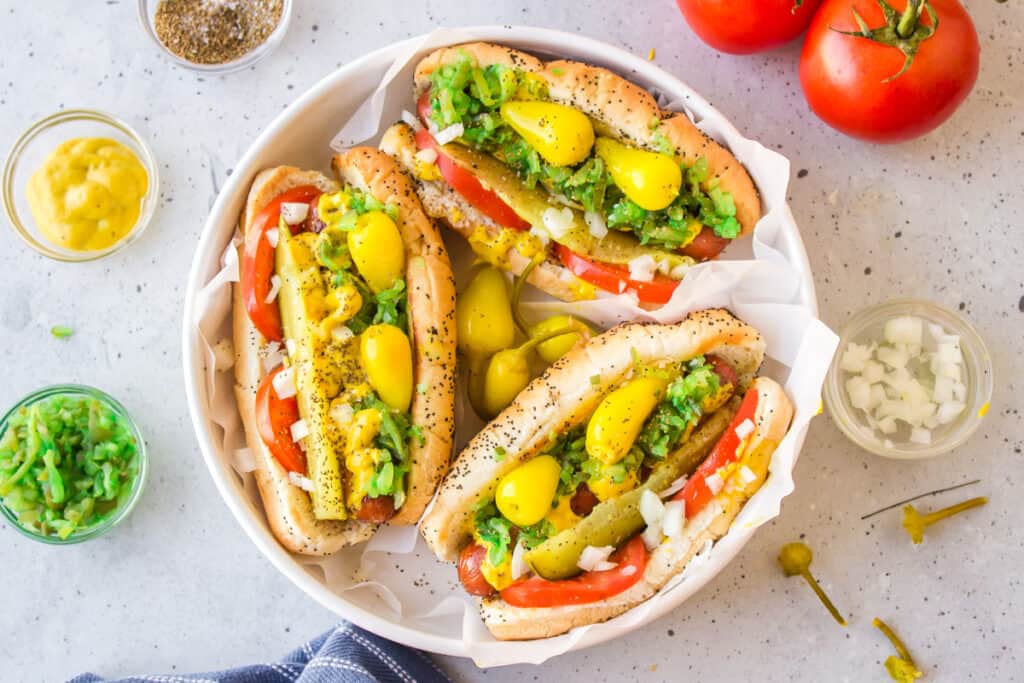 Chicago Style Hot Dogs — The Dragged Through the Garden Classic Done Right 26 chicago style hot dog beautifully plated with all classic toppings on poppy seed bun, overhead shot on wooden board