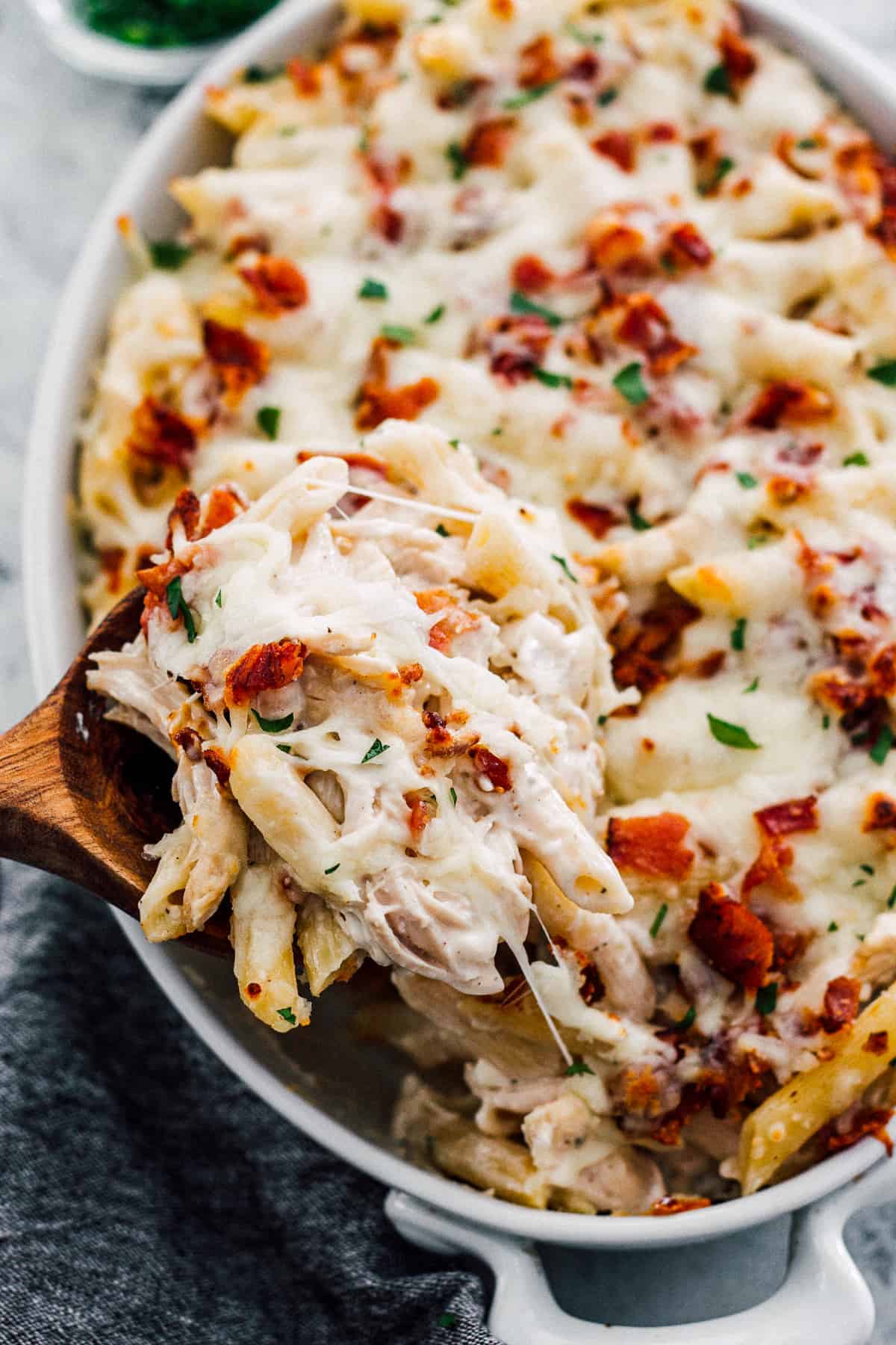 Chicken Bacon Ranch Pasta Bake — Creamy, Cheesy Comfort Food the Whole Family Will Love 27 Chicken Bacon Ranch Pasta Bake ingredients laid out flat on a white marble surface — raw pasta, shredded chicken, crispy bacon strips, ranch seasoning, shredded cheddar, cream cheese, and fresh herbs