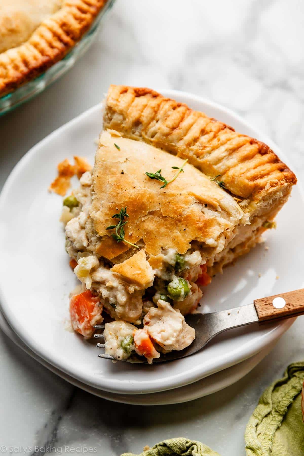 Chicken Pot Pie — Creamy Filling, Flaky Double Crust, Pure Comfort 26 golden homemade chicken pot pie with flaky double crust, sliced open to reveal creamy vegetable filling, styled on a rustic wooden table