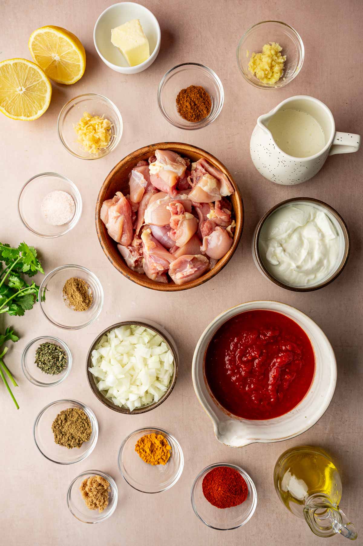 Chicken Tikka Masala — Rich, Aromatic, and Deeply Satisfying 27 Flat lay of Chicken Tikka Masala ingredients including whole spices, fresh ginger, garlic, yogurt, crushed tomatoes, and raw chicken thighs arranged on a marble surface