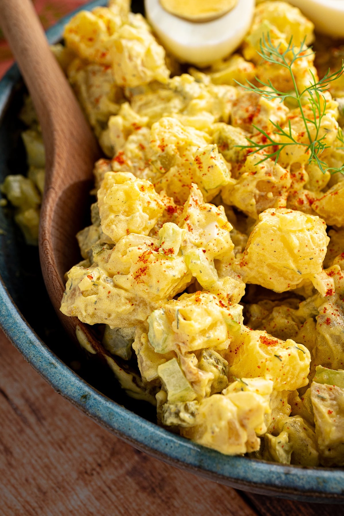 Overhead flat lay of Classic Potato Salad ingredients including Yukon Gold potatoes, hard-boiled eggs, mustard, celery, and relish on a white marble surface