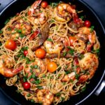 Creamy Tuscan Chicken served in a white skillet with golden pan-seared chicken breasts nestled in a rich spinach and sun-dried tomato cream sauce, garnished with fresh basil
