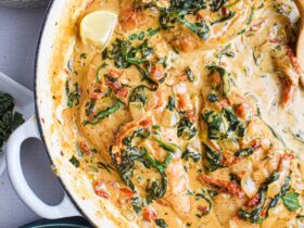 Creamy Tuscan Chicken — Pan-Seared in Spinach and Sun-Dried Tomato Cream Sauce 19 Creamy Tuscan Chicken served in a white skillet with golden pan-seared chicken breasts nestled in a rich spinach and sun-dried tomato cream sauce, garnished with fresh basil