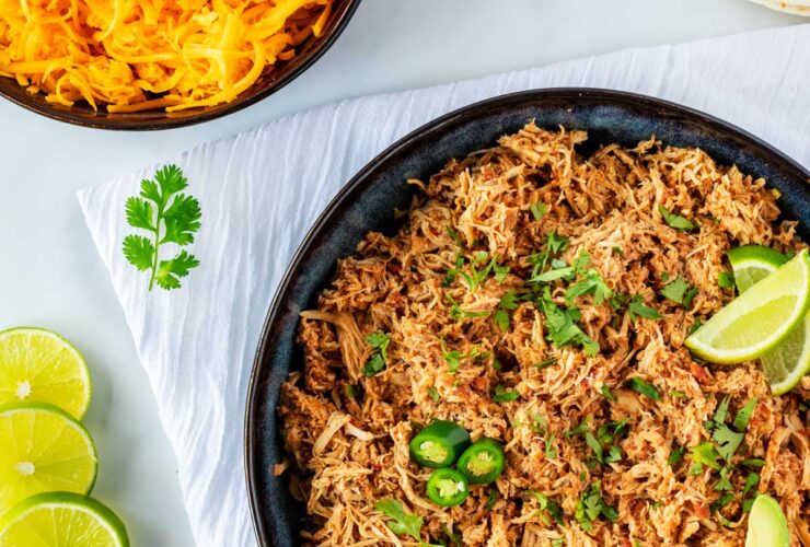 Crockpot Salsa Chicken — The Easy 3-Ingredient Shredded Chicken for Tacos, Bowls & Wraps 27 Crockpot Salsa Chicken served in a white bowl over cilantro lime rice, topped with avocado slices, pico de gallo, and a lime wedge