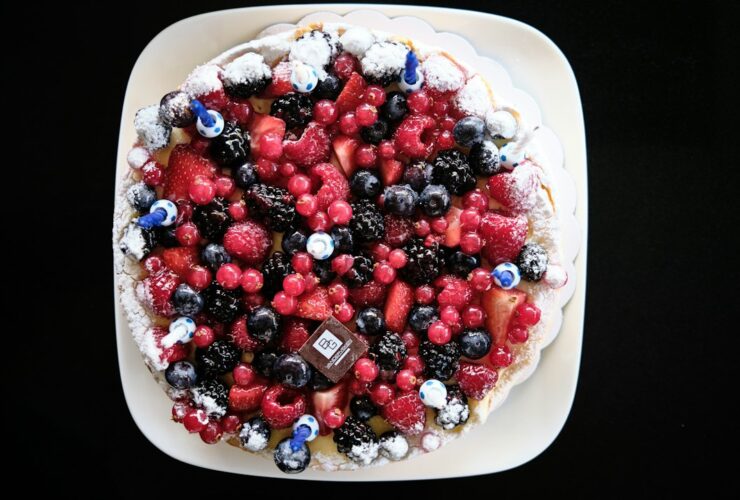 Frozen Greek Yogurt Berry Bark — The Healthy Dessert You'll Make All Summer 48 Frozen Greek yogurt berry bark broken into pieces on a white marble surface, topped with fresh strawberries, blueberries, and raspberries, drizzled with honey, bright natural lighting