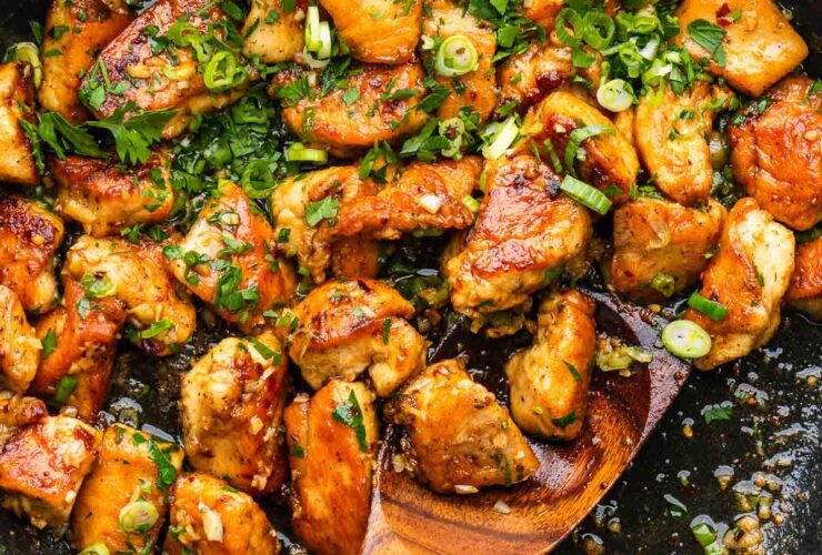 Garlic Butter Chicken Bites and Potatoes — Skillet Dinner Ready in 25 Minutes 27 Garlic Butter Chicken Bites and Potatoes served in a cast iron skillet, garnished with fresh parsley and lemon wedges on a rustic wooden table