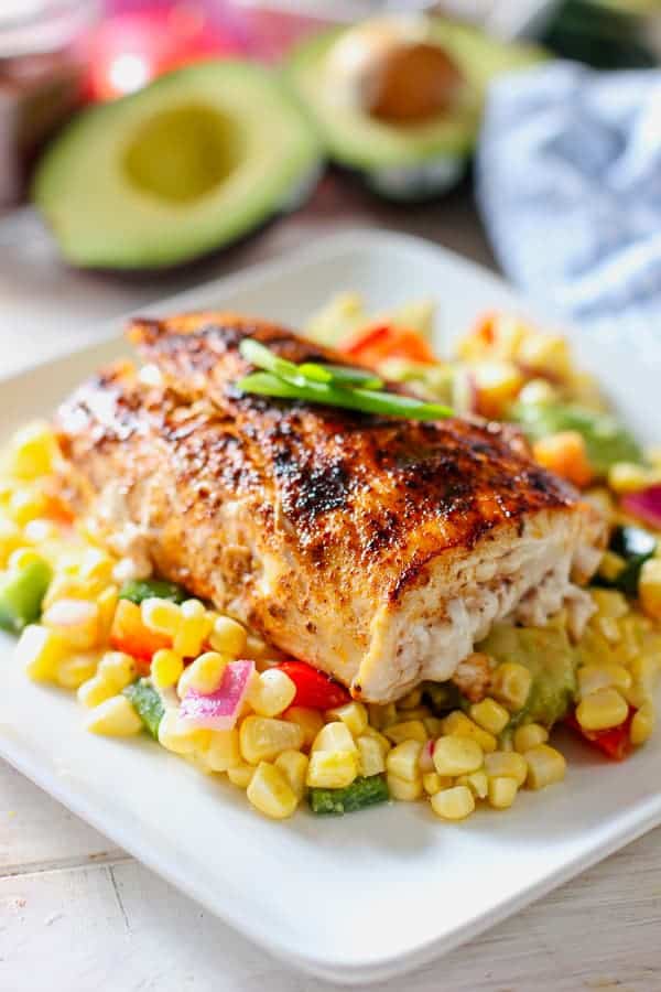 Ingredients for Grilled Fish Tacos with Corn Salsa laid out flat — spice rub spices, fresh corn, jalapeño, mahi-mahi fillets, limes, and tortillas