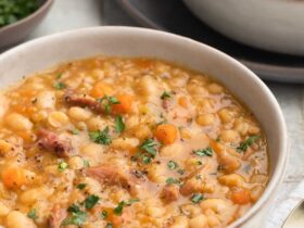 Ham and Bean Soup — Smoky, Hearty & Made from a Leftover Ham Bone 30 A rustic bowl of ham and bean soup with creamy white beans, tender chunks of ham, and fresh parsley garnish, photographed overhead on a wooden table
