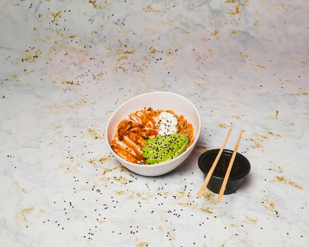 Hawaiian Poke Bowl — Fresh, Healthy, and Better Than Takeout 26 Hawaiian poke bowl with sushi-grade ahi tuna, steamed rice, edamame, cucumber, avocado, and sesame seeds in a white ceramic bowl, overhead shot, bright natural light