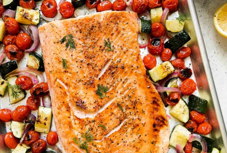 Herb-Crusted Salmon with Summer Vegetables — A One-Pan Mediterranean Dinner 27 Herb-crusted salmon fillet with golden herb crust served on a white platter surrounded by roasted summer vegetables including zucchini, cherry tomatoes, and bell peppers, garnished with fresh basil and lemon wedges