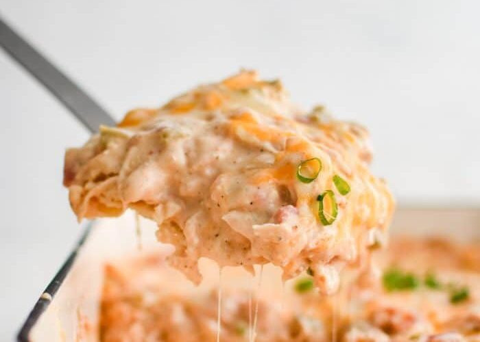 King Ranch Chicken Casserole — The Ultimate Tex-Mex Comfort Bake 27 King Ranch Chicken Casserole served in a white baking dish with bubbling cheese and fresh cilantro garnish on a rustic wooden table