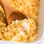 Million Dollar Chicken Casserole golden cracker topping baked in a white casserole dish, scooped onto a plate showing creamy chicken filling