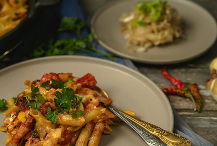 One Pot Creamy Cajun Chicken Pasta served in a wide skillet with andouille sausage, colorful bell peppers, and a golden creamy sauce, garnished with fresh parsley