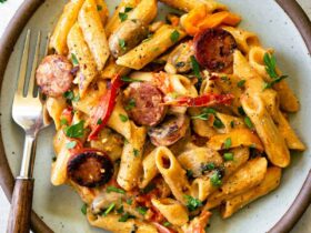One Pot Creamy Cajun Chicken Pasta — Spicy, Smoky & Ready in 45 Minutes 17 One Pot Creamy Cajun Chicken Pasta served in a wide skillet with andouille sausage, colorful bell peppers, and a golden creamy sauce, garnished with fresh parsley