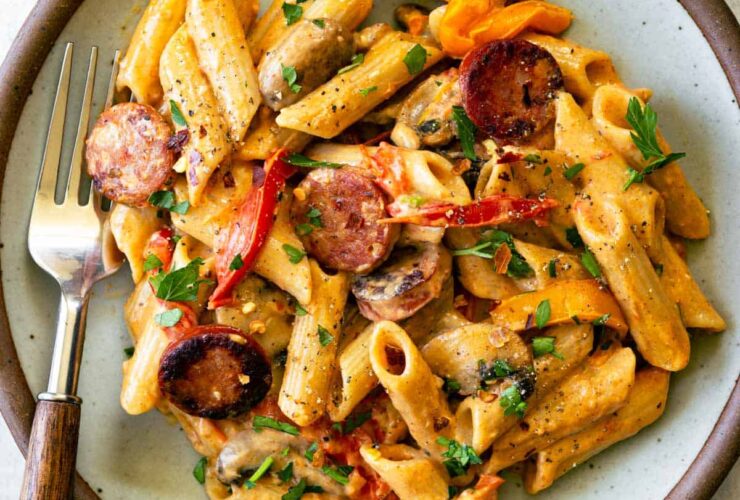 One Pot Creamy Cajun Chicken Pasta — Spicy, Smoky & Ready in 45 Minutes 27 One Pot Creamy Cajun Chicken Pasta served in a wide skillet with andouille sausage, colorful bell peppers, and a golden creamy sauce, garnished with fresh parsley