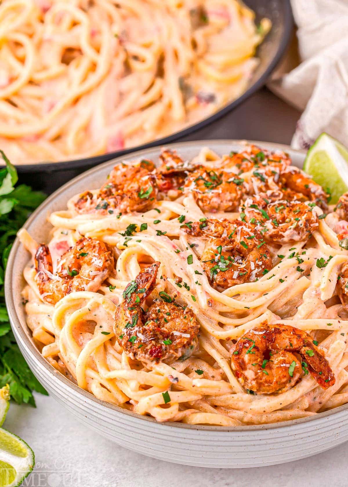 One Pot Creamy Cajun Chicken Pasta — Spicy, Smoky & Ready in 45 Minutes 28 Close-up of creamy Cajun chicken pasta in a bowl with visible chunks of andouille sausage, red bell pepper, and penne pasta coated in a rich golden cream sauce, topped with fresh parsley